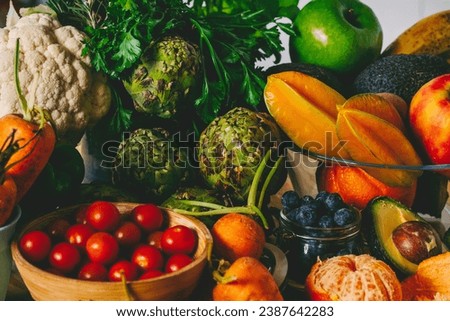 Sweet mix of fruits and vegetables bio organic raw on the table. Healthy food lifestyle diet nutrition concept. Weight loss omega natural food in dark shadow colorful mood. Harvest farm products