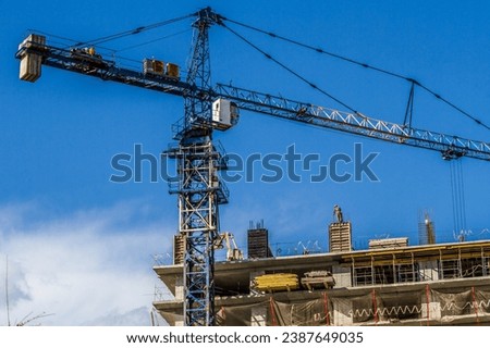 Cranes at work. Perfect for projects that demand energy and excitement Royalty-Free Stock Photo #2387649035