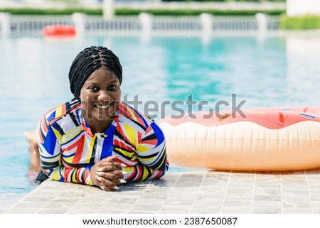 African woman happy relax at swimming pool summer holiday travel vacations. Black tourist girl swimming at luxury resort.