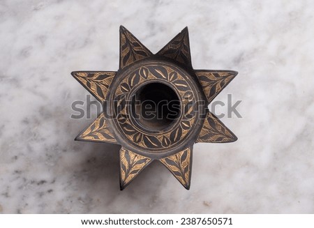 Antique retro style star shaped ashtray isolated in white background  Royalty-Free Stock Photo #2387650571