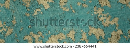 Peeling paint on the wall. Panorama of a concrete wall with old cracked flaking paint. Weathered rough painted surface with patterns of cracks and peeling. Wide panoramic grunge texture for background Royalty-Free Stock Photo #2387664441