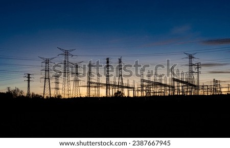 Electrical substation and power lines at sunset Royalty-Free Stock Photo #2387667945