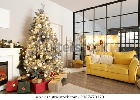 Interior of living room with Christmas tree, yellow sofa and folding screen