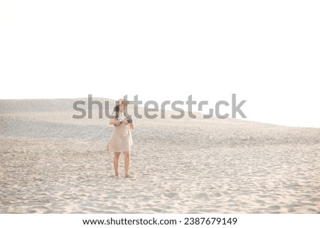 Happy asian woman taking a photo with digital camera at desert