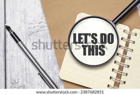 LET's DO THIS words on magnifying glass with pen and papers
