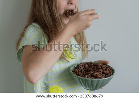 Little Blond Girl Eating Chocolate Flakes Indoor 