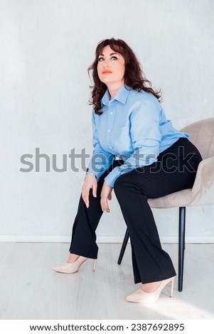 woman sitting in a chair on a white background business finance business style