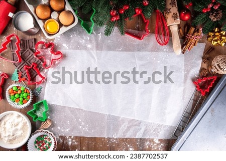 Cooking Christmas cookies family background. Mother and daughter hands top view on cozy wooden background, making gingerbread biscuits with cookie cutters, with New Year Christmas decoration