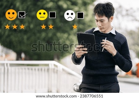 Male businessman holding a digital tablet with checkboxes rating smiley faces excellent for Satisfaction Survey, Happy Client Customer Experience concept.