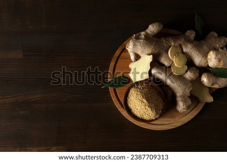 Fresh ginger root with ginger powder in a bowl