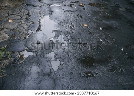 Wet asphalt road and water puddles after rain situation