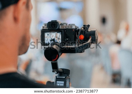 Filming of the event. Videography. Royalty-Free Stock Photo #2387713877