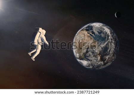 Cosmonaut in outer space against Earth planet. Elements of this image furnished by NASA.