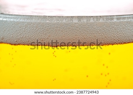 Golden beer close-up with foam on the top