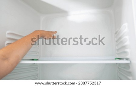 Ice and snow build up on the back wall of the refrigerator. Refrigerator failure, freon leak, temperature sensor defective. Royalty-Free Stock Photo #2387752317