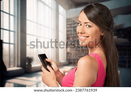 Smiling happy business woman holding smartphone