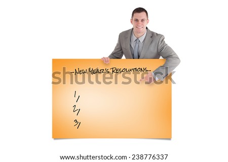 Portrait of a smiling entrepreneur pointing at something against orange card