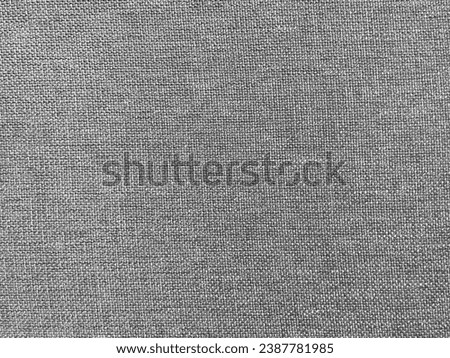 Photo of full screen frame cloth fabric texture fiber material in a grey gray color or colout that can be use as a background