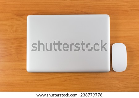 Laptop on wood table Royalty-Free Stock Photo #238779778