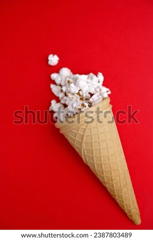 waffle cone with popcorn on a red background close-up