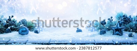 Winter decoration with a blue star and snowflakes on a snowy landscape background Royalty-Free Stock Photo #2387812577