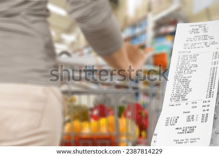 Woman with supermarket trolley and big check