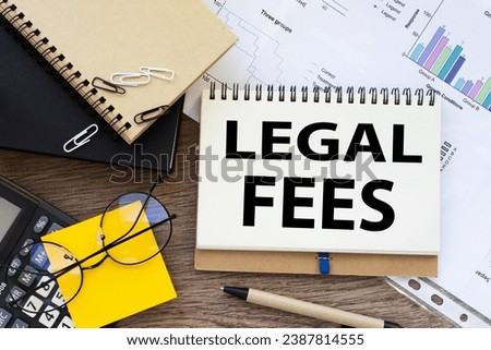 LEGAL FEES . Business. yellow sticker on the calculator. financial charts. text on the envelope
