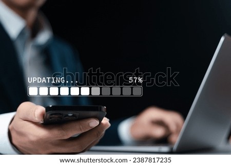 Businessman downloading and installing update process. Software updates or operating system upgrades to keep your device up to date with enhanced functionality in new versions and improved security