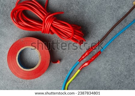 Insulated electrical wires and electrical tape. Top view. Royalty-Free Stock Photo #2387834801