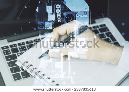 Double exposure of creative artificial Intelligence symbol with hand writing in notebook on background with laptop. Neural networks and machine learning concept