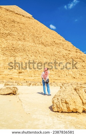Woman tourist takes photographs of the Pyramid of Khafre.  Giza, Egypt - October 16, 2023 