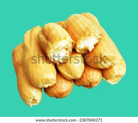Eclairs isolated in green background, no shadow with clipping path, sweet food, bakery