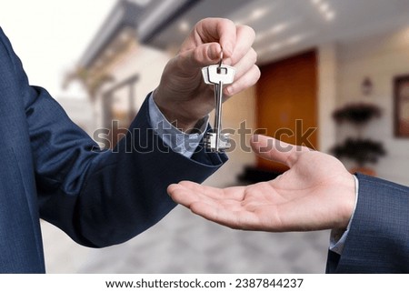 Handing the home keys between realtor and new owner. sale concept