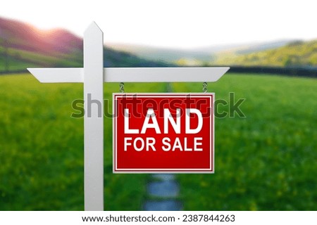Land for sale. Land for sale sign on green grass. Purchase of site plot. Purchase of empty land. Purchase of site for construction of house. Sign advertising ground on clipped grass background