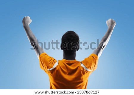 Portrait of young happy man football player winning