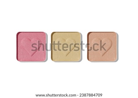 Top view of set pastel color eye shadow swatch isolated on white background with shadow, eyeshadows with heart imprint, colored powder for makeup, square shape in metal pack, beauty design object