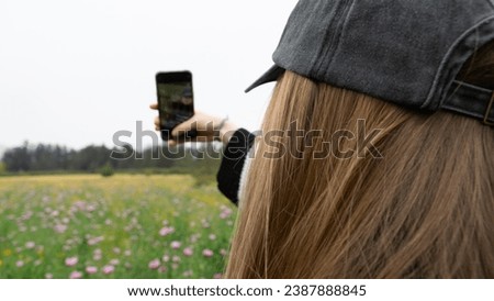 Woman taking a selfie in nature.