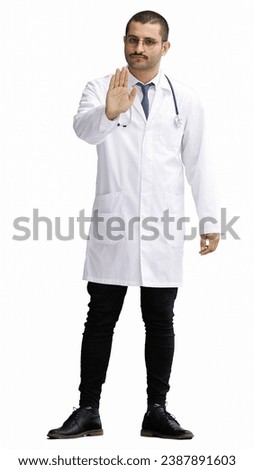 male doctor in a white coat on a white background shows a stop sign
