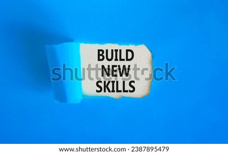 Build new skills symbol. Concept word Build new skills on beautiful white paper. Beautiful blue table blue background. Business, education build new skills concept. Copy space.