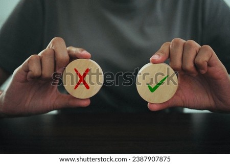 Woman holding right and wrong icons The concept of making the right decision.