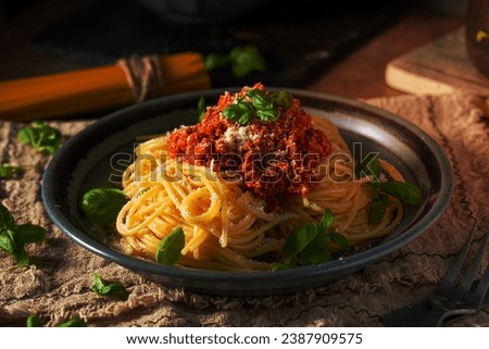Delicious pasta with basil, parmesan cheese and bolognese sauce