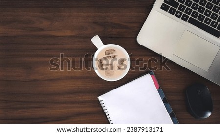Desk office with notepad, coffee cup and laptop on the table