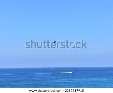 parachute flight over the sea behind a boat