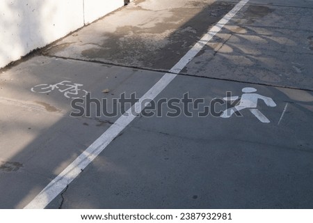 Pedestrian path with a sign painted on the asphalt. Horizontal photo