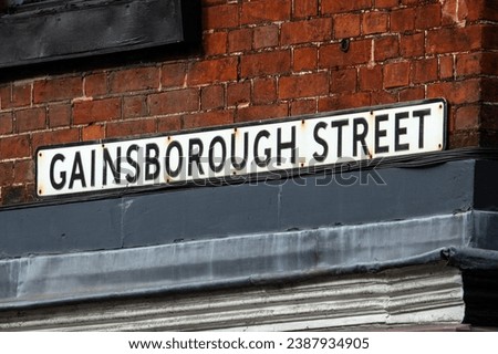 Close-up of the street sign for Gainsborough Street in the town of Sudbury in Suffolk, UK.