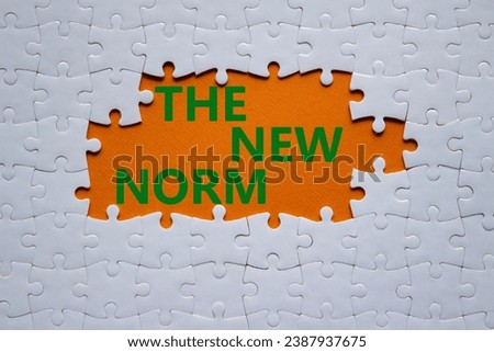 The new norm symbol. Concept words The new norm on white puzzle. Beautiful orange background. Business and The new norm concept. Copy space. Royalty-Free Stock Photo #2387937675