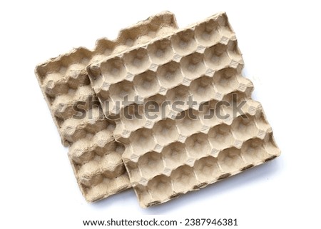 Paper egg crate tray on white background. Royalty-Free Stock Photo #2387946381