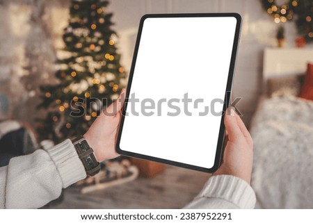 Girl working on a graphics tablet with isolated screen in a Christmas atmosphere.
