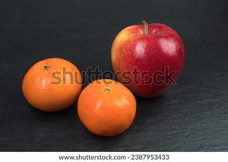 Fruits. Apples, oranges tangerines on a black background