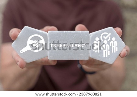 Man holding white styrofoam blocks sees word: TRANSPARENCY. Concept of business transparency. Honest and clean company. Financial and economical stats sharing, publication and presentation.